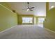 Spacious open concept living room with neutral walls, clerestory windows, and modern ceiling fan at 5037 Sw 109Th Loop, Ocala, FL 34476