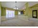 Spacious living room with large windows, decorative wallpaper, and neutral carpeting at 5037 Sw 109Th Loop, Ocala, FL 34476