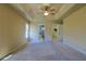 Spacious main bedroom features a tray ceiling, carpet, and ensuite bathroom and walk-in closet at 5037 Sw 109Th Loop, Ocala, FL 34476