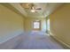 Spacious main bedroom with carpeted flooring, ceiling fan, and ample natural light at 5037 Sw 109Th Loop, Ocala, FL 34476