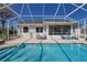 A refreshing screened-in pool with ample seating and a patio, perfect for entertaining at 5037 Sw 109Th Loop, Ocala, FL 34476