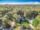 Aerial view showcasing a house and its spacious, tree-lined backyard in a residential area at 5150 Se 47Th Court Rd, Ocala, FL 34480