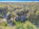 Aerial view of sprawling home surrounded by lush green landscape and trees at 5150 Se 47Th Court Rd, Ocala, FL 34480