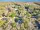 Aerial view of a home surrounded by mature trees in a quiet neighborhood at 5150 Se 47Th Court Rd, Ocala, FL 34480