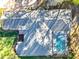 An aerial view of a well-maintained house with a screened-in pool and a gray shingle roof at 5150 Se 47Th Court Rd, Ocala, FL 34480