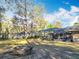 Spacious backyard featuring a screened lanai and a fire pit, perfect for outdoor enjoyment at 5150 Se 47Th Court Rd, Ocala, FL 34480