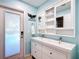 Charming bathroom with double sink vanity, custom mirror and lighting, and door to the exterior at 5150 Se 47Th Court Rd, Ocala, FL 34480