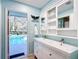 Charming bathroom with double sink vanity, custom mirror and lighting, and access to screened-in pool at 5150 Se 47Th Court Rd, Ocala, FL 34480