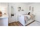 Well-lit bedroom with wood flooring, cozy decor, and a stylishly arranged daybed at 5150 Se 47Th Court Rd, Ocala, FL 34480