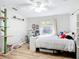 Bedroom featuring wood floors, a desk, and bright natural light at 5150 Se 47Th Court Rd, Ocala, FL 34480