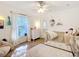 Bright bedroom featuring light wood floors, soft white walls, and a cozy daybed at 5150 Se 47Th Court Rd, Ocala, FL 34480
