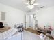 Bright bedroom with wood floors, a desk, and natural light from a large window at 5150 Se 47Th Court Rd, Ocala, FL 34480
