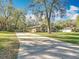 Charming single-Gathering home with mature landscaping and long concrete driveway at 5150 Se 47Th Court Rd, Ocala, FL 34480