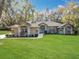 Charming stucco home with manicured lawn and mature landscaping at 5150 Se 47Th Court Rd, Ocala, FL 34480