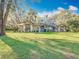 Inviting exterior with manicured lawn, stone accents, and a charming front door sets an elegant tone at 5150 Se 47Th Court Rd, Ocala, FL 34480