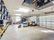 Well-organized three car garage with installed shelving and lawn equipment at 5150 Se 47Th Court Rd, Ocala, FL 34480