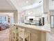 Open concept kitchen with bar seating, stainless steel appliances, and ample counter space at 5150 Se 47Th Court Rd, Ocala, FL 34480