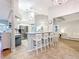 Spacious kitchen with white cabinetry, bar seating, and open layout at 5150 Se 47Th Court Rd, Ocala, FL 34480
