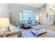 Bright and airy living room featuring comfortable seating, a large window, and stylish decor, perfect for relaxation at 5150 Se 47Th Court Rd, Ocala, FL 34480