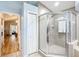 Main bathroom featuring a glass shower, closet, and an entrance to the hallway with wood-look flooring at 5150 Se 47Th Court Rd, Ocala, FL 34480
