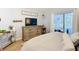 Bright main bedroom with wood-look floors, lots of natural light, and a view of the patio at 5150 Se 47Th Court Rd, Ocala, FL 34480
