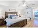 Spacious bedroom featuring a shiplap wall, wood floors, and seating area with lots of natural light at 5150 Se 47Th Court Rd, Ocala, FL 34480