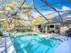 Beautiful pool with screened enclosure and access to outdoor living area at 5150 Se 47Th Court Rd, Ocala, FL 34480