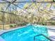 Enclosed pool with covered structure and views of surrounding trees at 5150 Se 47Th Court Rd, Ocala, FL 34480