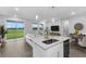 Open-concept living area featuring an island with a sink, plus a large sliding glass door to the yard at 5270 Nw 33Rd Pl, Ocala, FL 34482