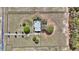 An aerial view shows a home with fenced perimeter surrounded by green pastures at 5560 Ne 31St Ter, Ocala, FL 34479