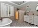 Bathroom features modern fixtures, double vanity, and a separate tub and shower at 5560 Ne 31St Ter, Ocala, FL 34479