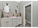 Bathroom featuring double sinks, tile floors, and modern finishes at 5560 Ne 31St Ter, Ocala, FL 34479