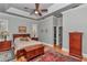 Spacious bedroom with wood floors, ceiling fan, and en-suite bathroom with walk-in closet at 5560 Ne 31St Ter, Ocala, FL 34479