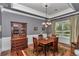 Elegant dining room featuring hardwood floors, beautiful chandelier, and classic china cabinet at 5560 Ne 31St Ter, Ocala, FL 34479