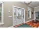 Elegant foyer with wood floors, decorative front door, and classic trim detailing at 5560 Ne 31St Ter, Ocala, FL 34479