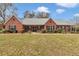 Charming brick home featuring a well-manicured lawn, classic shutters, and a welcoming front porch at 5560 Ne 31St Ter, Ocala, FL 34479