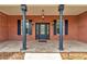 Inviting front porch with brick columns, tiled floor, and a stylish front door with sidelights at 5560 Ne 31St Ter, Ocala, FL 34479