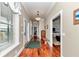Long hallway featuring wood floors, elegant lighting, and views of other rooms in the home at 5560 Ne 31St Ter, Ocala, FL 34479