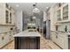 Spacious kitchen features a large island with a cooktop and stainless steel appliances at 5560 Ne 31St Ter, Ocala, FL 34479