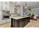 The open kitchen is equipped with stainless appliances and a large island for cooking and entertaining at 5560 Ne 31St Ter, Ocala, FL 34479