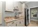 Convenient laundry area with granite countertops, sink, refrigerator, and plenty of storage at 5560 Ne 31St Ter, Ocala, FL 34479