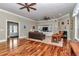 Spacious living room with hardwood floors, fireplace, built-in shelves, and comfortable seating at 5560 Ne 31St Ter, Ocala, FL 34479