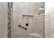 Close-up view of custom shower with sleek tile design and built-in niche at 5560 Ne 31St Ter, Ocala, FL 34479