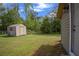 The spacious backyard features a shed and lush greenery at 5615 Se 113Th Pl, Belleview, FL 34420