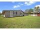 The exterior of the home has a serene backyard with a storage shed, and lush greenery at 5615 Se 113Th Pl, Belleview, FL 34420