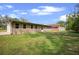 A sprawling backyard, a neutral exterior, and lush greenery at 5615 Se 113Th Pl, Belleview, FL 34420