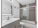 Bathroom with a gray vanity, a shower-tub combination with decorative tile, and neutral decor at 5615 Se 113Th Pl, Belleview, FL 34420