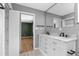 Bathroom with dual sinks and marble countertop adjacent to walk-in closet at 5615 Se 113Th Pl, Belleview, FL 34420