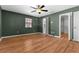 Bedroom featuring wood floors, natural light, and an adjacent walk-in closet at 5615 Se 113Th Pl, Belleview, FL 34420