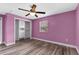 This bedroom features hardwood floors, built in shelving, and a window at 5615 Se 113Th Pl, Belleview, FL 34420